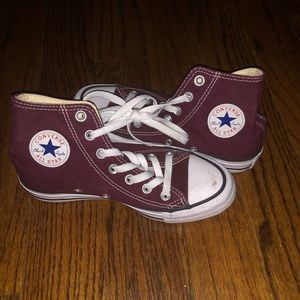 Maroon higher top converse.